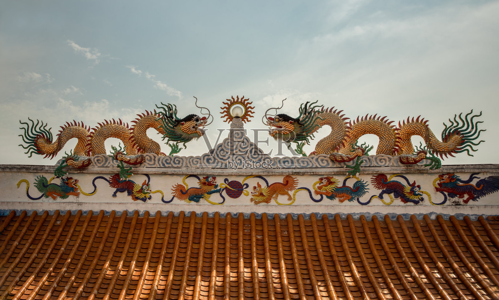双龙雕塑装饰在中式寺庙屋顶上。照片摄影图片