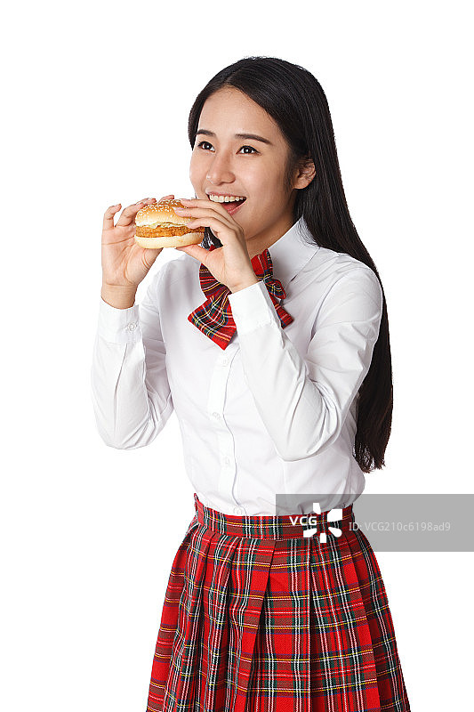 青春活力的青年女学生吃汉堡包图片素材
