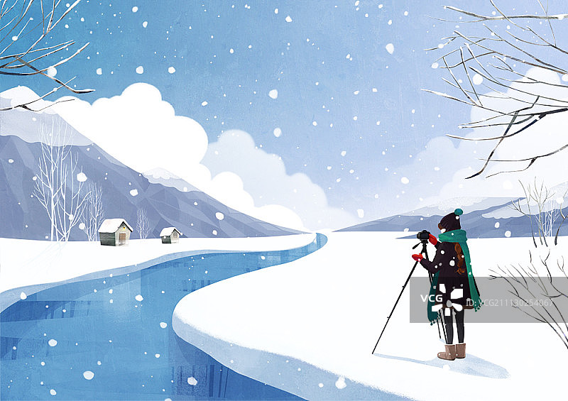 一个女人正在拍摄冬天的景色图片素材
