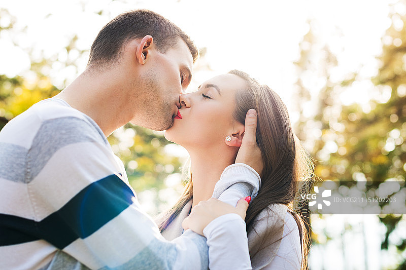 幸福的年轻情侣在热吻。公园户外约会。爱的夫妻关系。图片素材