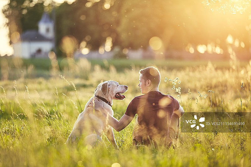 日落时分，一个男人和他的狗图片素材