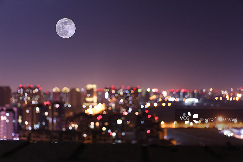 霓虹璀璨，皓月当空，历经繁忙的城市，进入安详的夜晚。图片素材