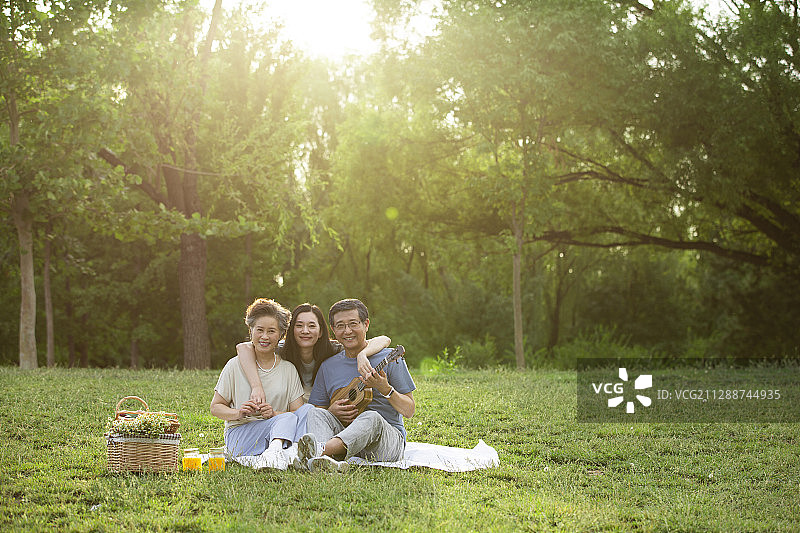 老年父母和女儿在户外公园野餐郊游图片素材