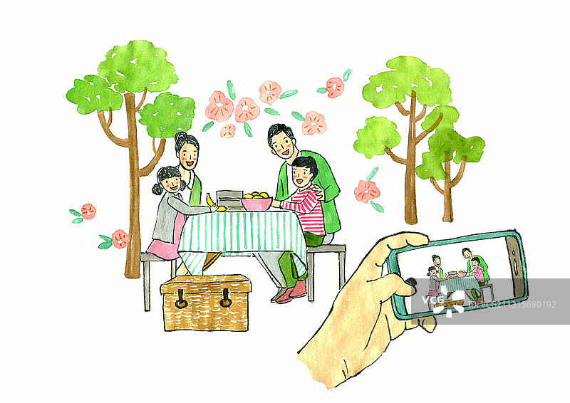 家庭围坐在公园的餐桌旁野餐的照片图片素材