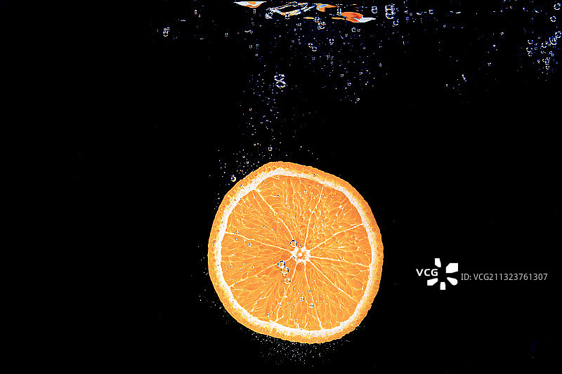 特写的橙色水果对黑色的背景图片素材