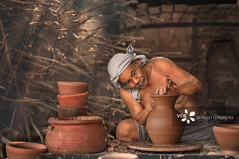 泰国乌汶府，工匠们在车轮上用湿粘土制作陶器图片素材