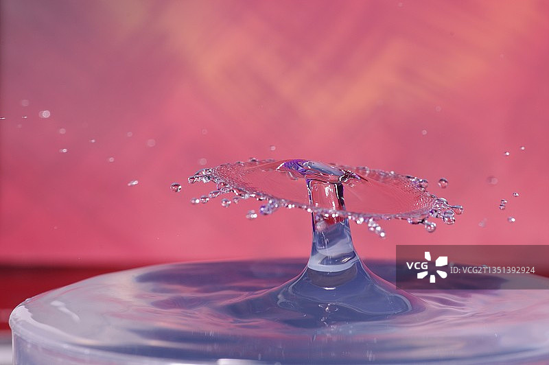 溅起的水滴在彩色背景下的特写，日本图片素材