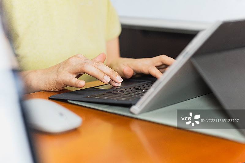女商人在笔记本电脑键盘上打字，从家里工作的概念，泰国图片素材