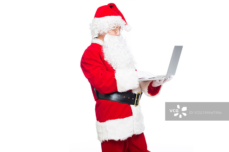 圣诞老人使用笔记本电脑图片素材