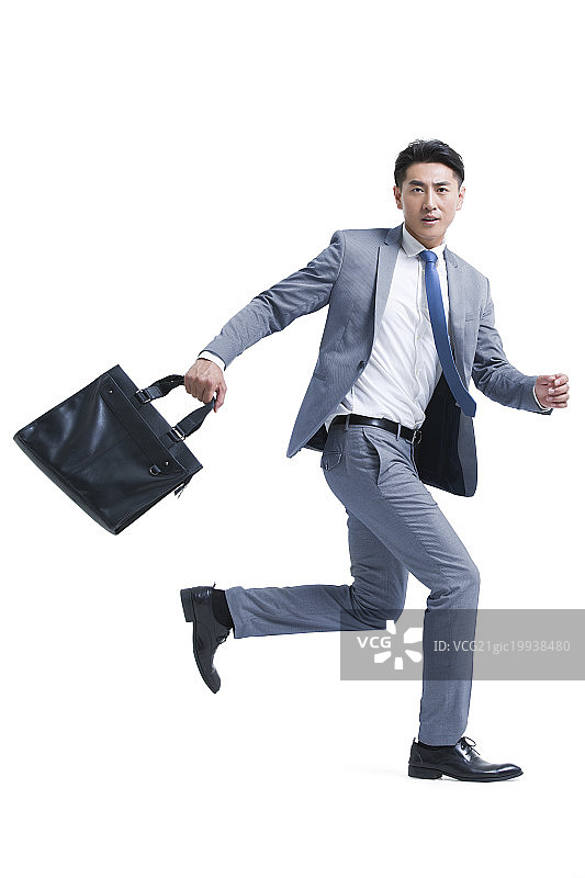 年轻商务男子拿着公文包奔跑图片素材