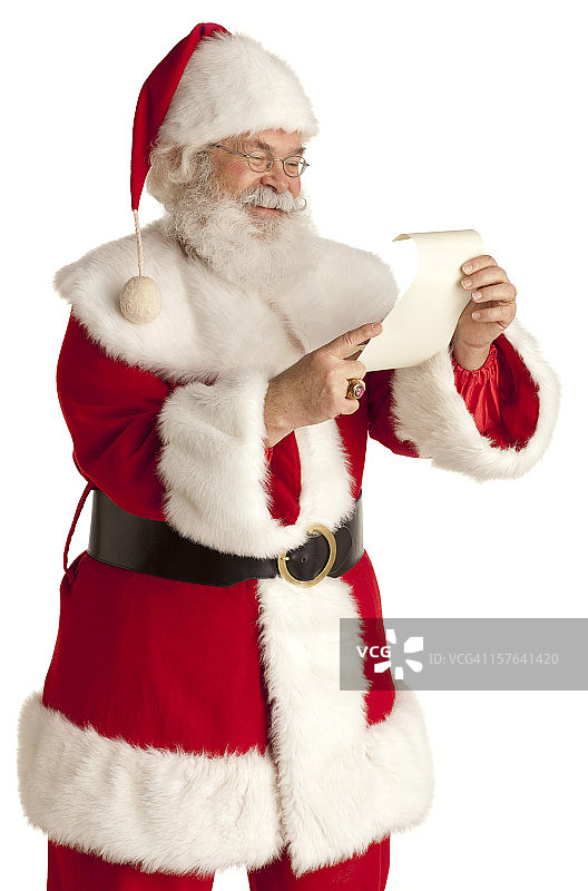圣诞老人在检查他的名单。白色背景。图片素材