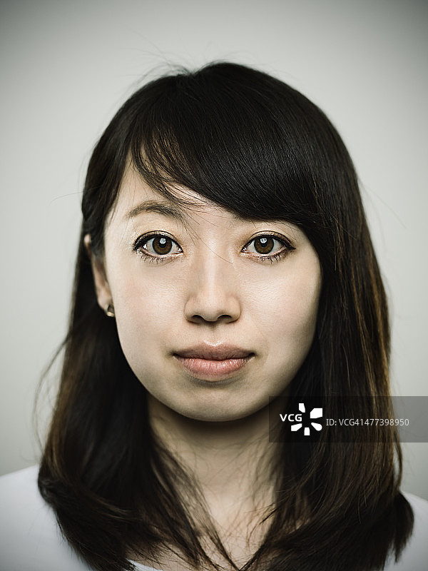 一个年轻的日本女人看着相机的肖像图片素材