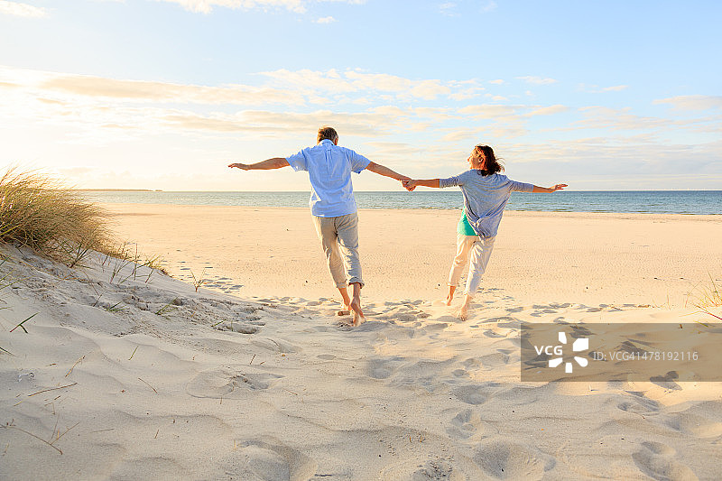 一对快乐的成熟夫妇在沙滩上图片素材