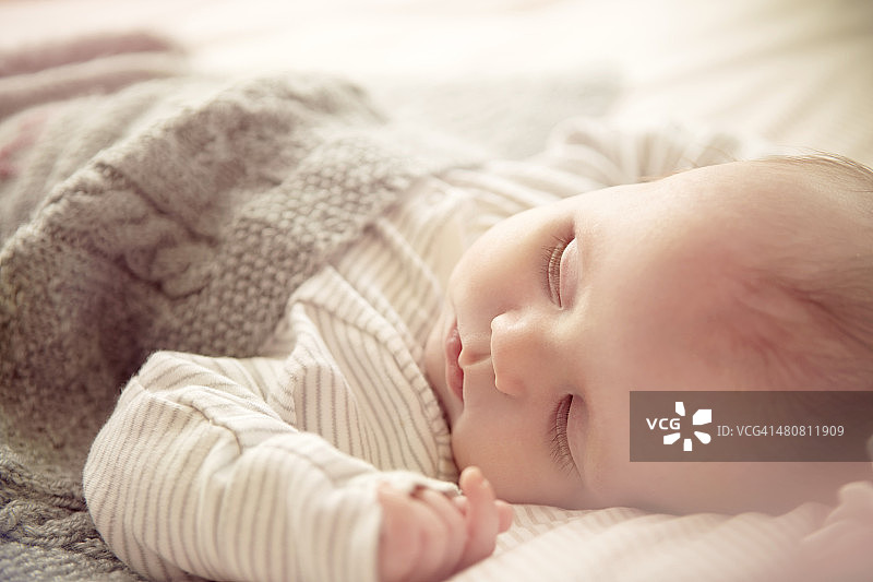两个月大的男婴在婴儿床上睡觉图片素材