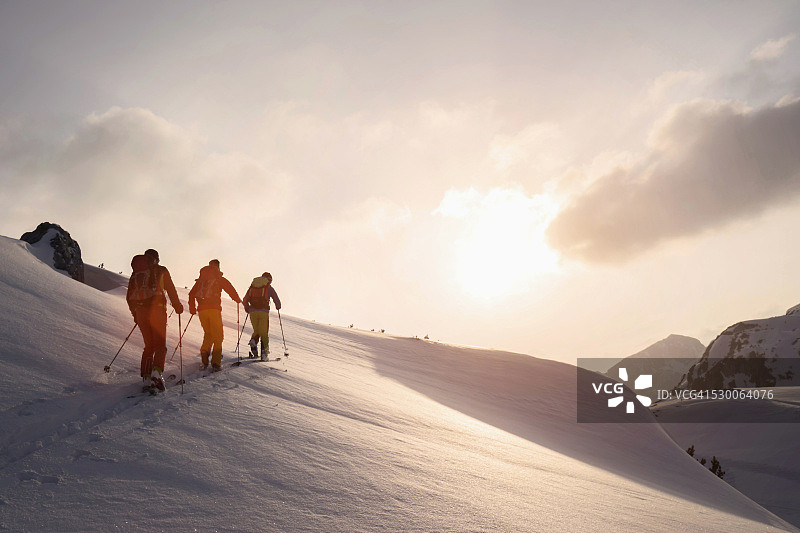 奥地利蒂罗尔，滑雪登山运动员在雪山上攀登图片素材