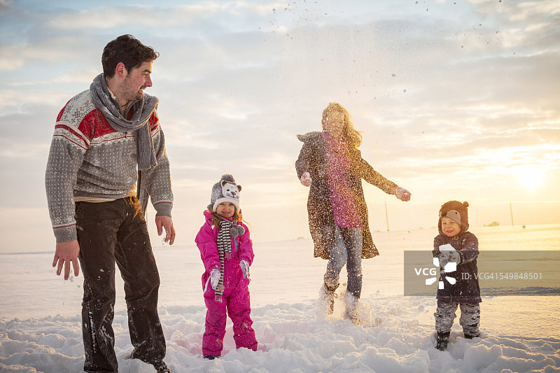 快乐的家庭在雪中嬉戏图片素材