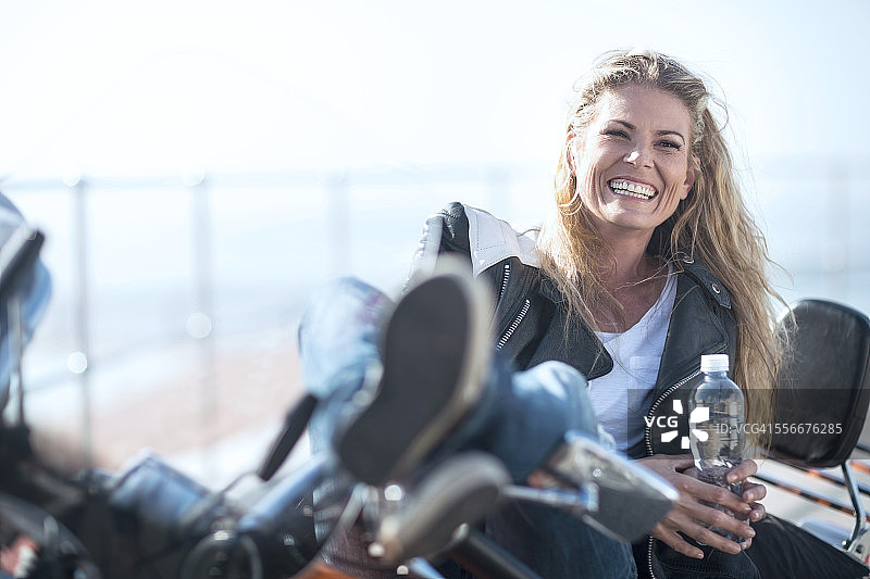 骑摩托车的女人正在休息图片素材
