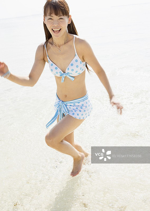在海滩上跑步的女人图片素材