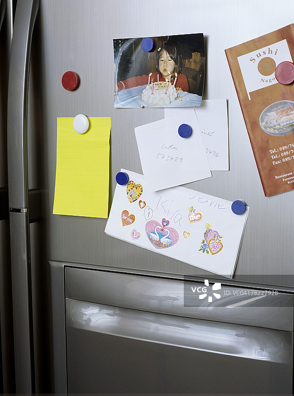 冰箱门上的笔记和照片图片素材