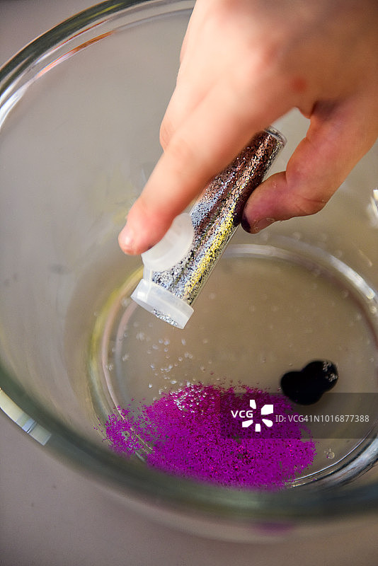 在碗中加入闪光银粉、水胶和食用色素制成黏液图片素材