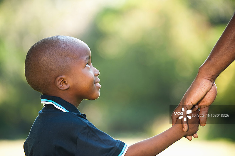 南非豪登省约翰内斯堡，男孩(4-5)牵着父亲的手图片素材