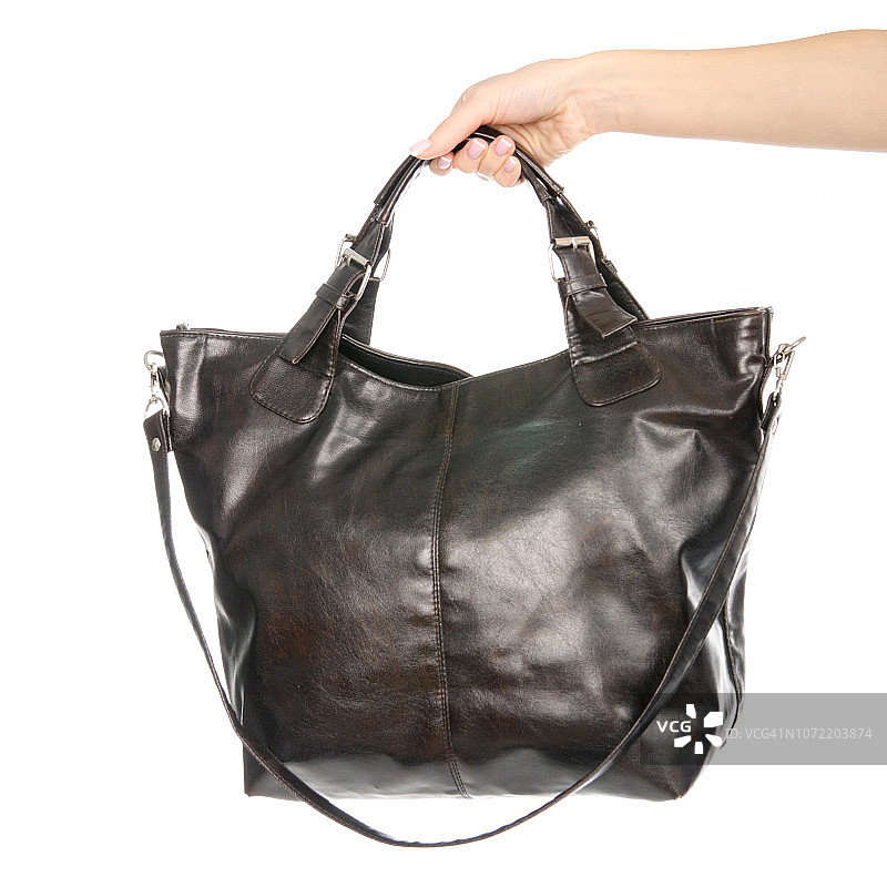 女人的女性黑色棕色皮包在手图片素材