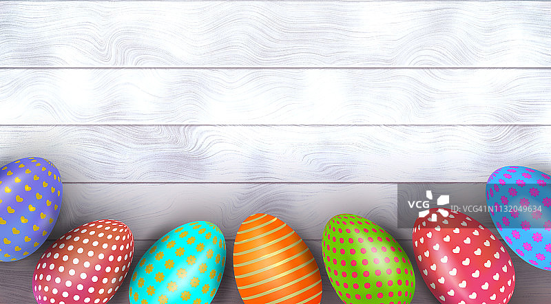 五彩缤纷的复活节彩蛋以不同的图案装饰在木制的背景上。俯视图图片素材