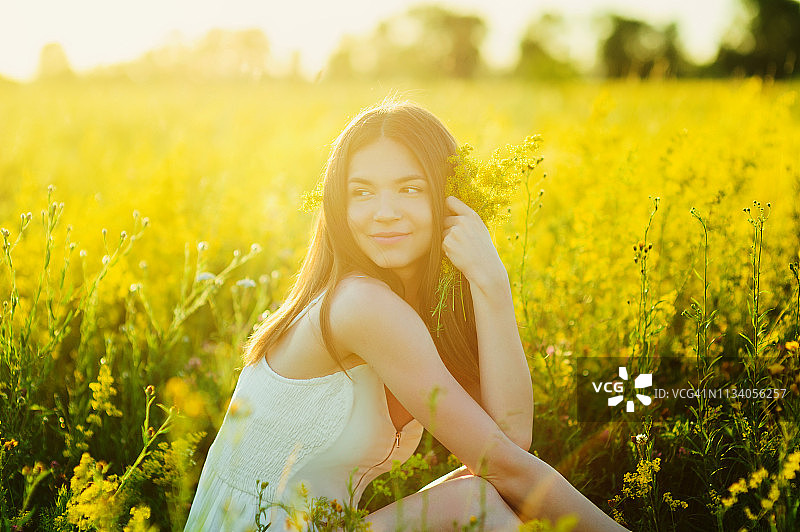 美丽的白人女孩在花的田野在夏天日落健康的生活方式图片素材