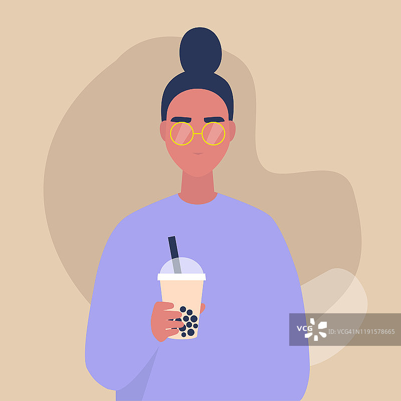 一个年轻的女性人物的肖像拿着一杯带走的珍珠奶茶，生活方式和食物图片素材