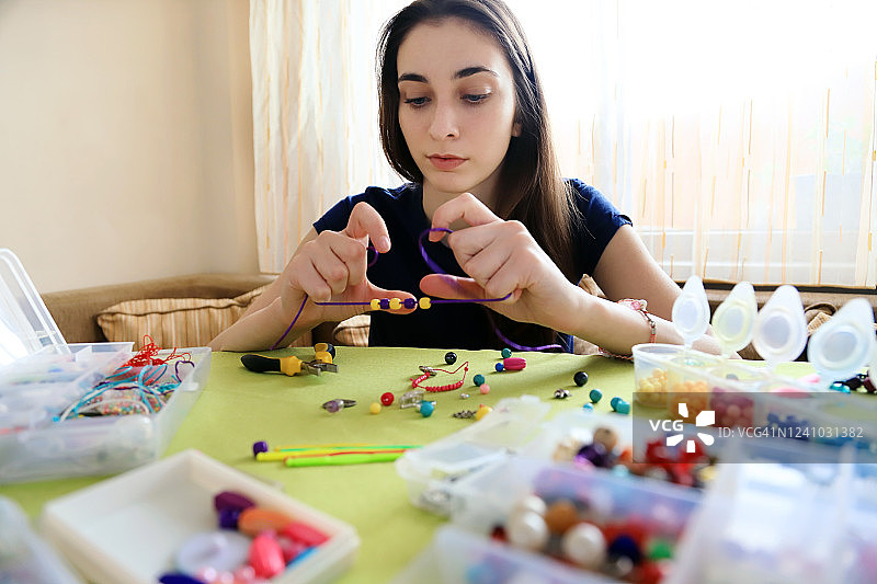 做珠子手镯的年轻女子图片素材