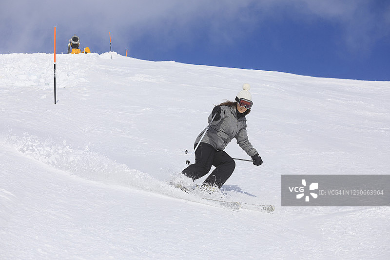 业余冬季运动年轻女子滑雪滑雪在阳光明媚的滑雪胜地Dolomites在意大利图片素材