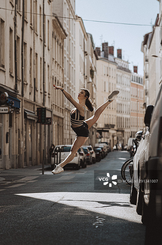 芭蕾舞演员穿着短裤和运动鞋在街上跳图片素材