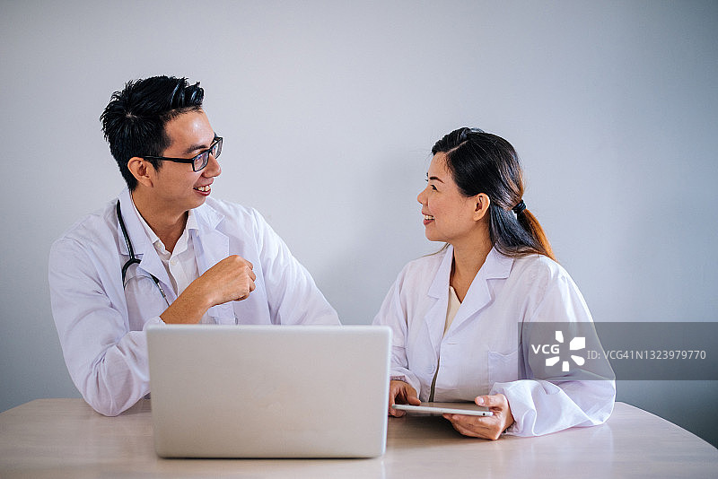 两个亚洲医生在会议期间使用笔记本电脑图片素材