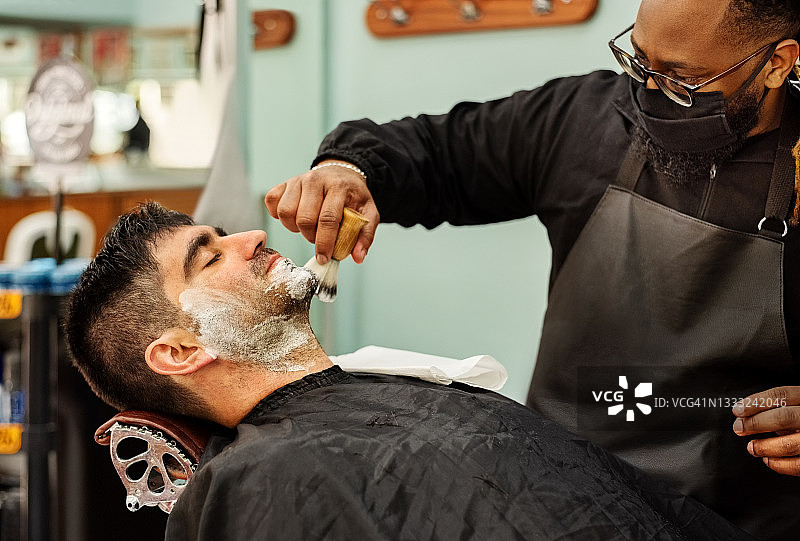 理发师给客户刮胡须图片素材