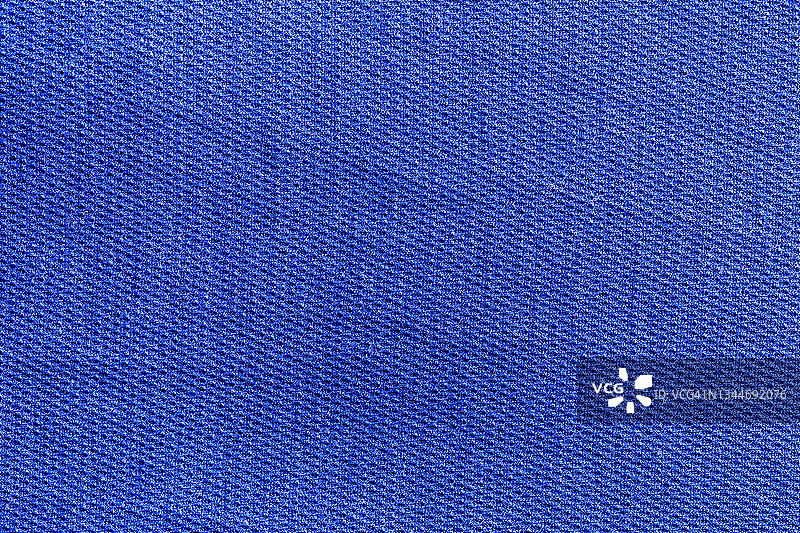 蓝色运动服装面料足球衬衫针织质地和织物背景。图片素材