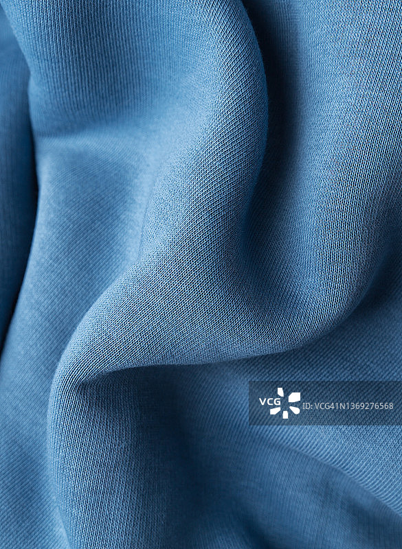 温暖柔软的面料作为背景。蓝色的织物。图片素材