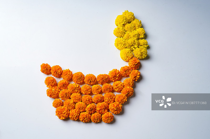 万寿菊花rangoli设计在油灯形状。图片素材