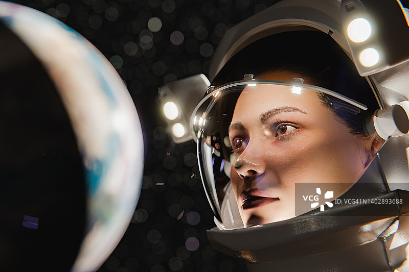 严肃的年轻女宇航员戴着头盔从太空看地球图片素材