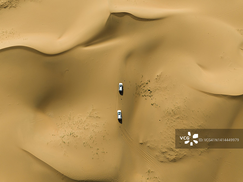 在沙漠中驾驶越野车，无人机视角图片素材