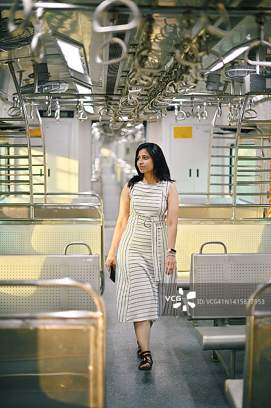 一个微笑的女人走在火车上图片素材