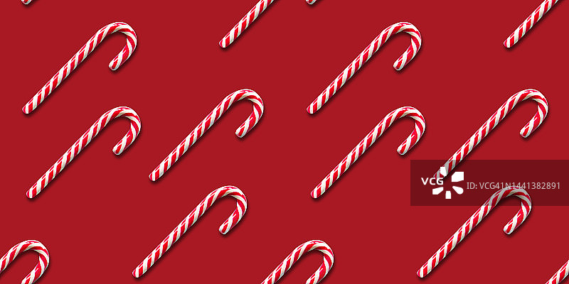 无缝模式的圣诞糖果拐杖上的红色背景。平的。图片素材