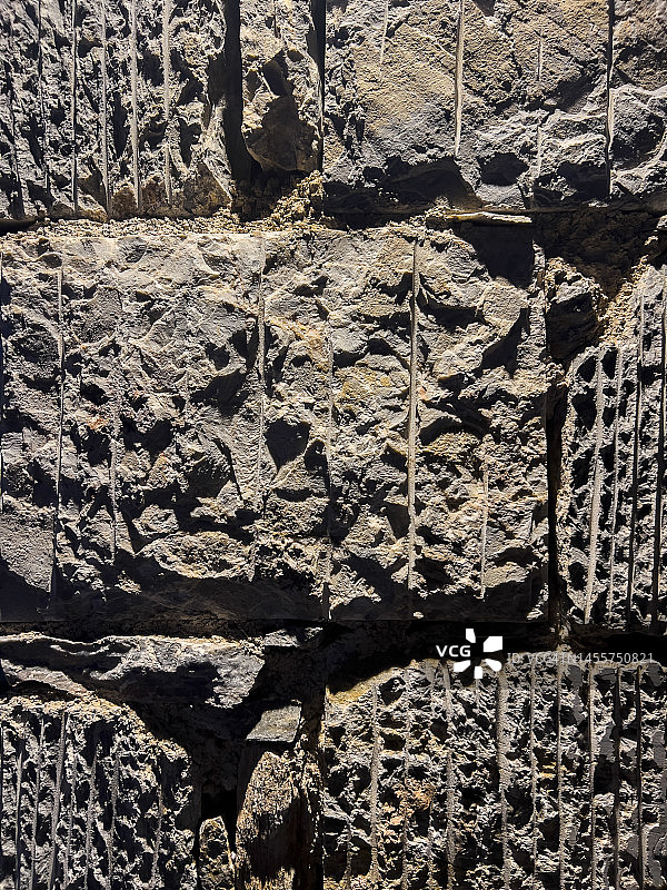 古老的灰色天然石墙，垂直图片素材