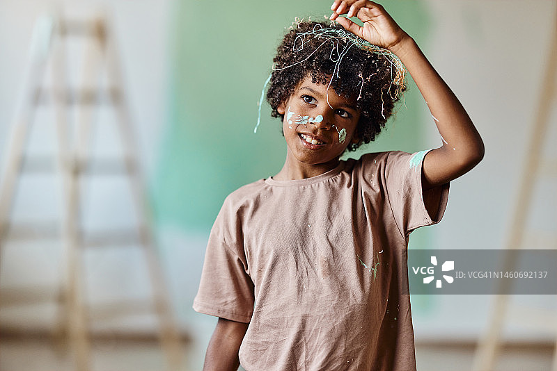 快乐的非裔美国男孩在家庭装修过程中。图片素材