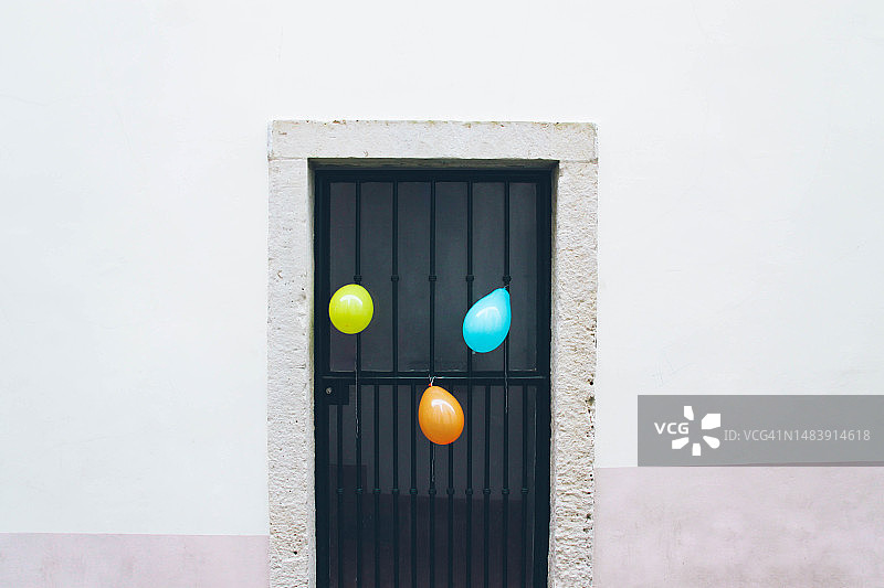 黑色的门上有三个彩色的气球图片素材