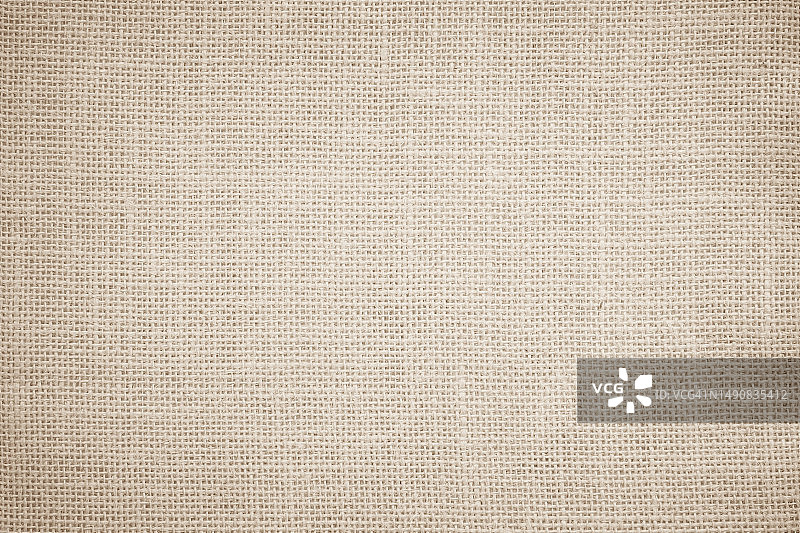 黄麻麻布麻布帆布编织纹理背景图案在浅米色，奶油棕色的空白。天然织造纤维亚麻与棉布质地一样干净空旷，便于装饰。图片素材