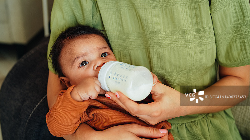 母亲用奶瓶喂她刚出生的男婴图片素材