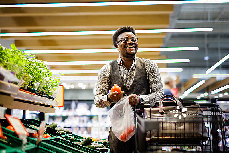 微笑的男人在超市买杂货图片素材