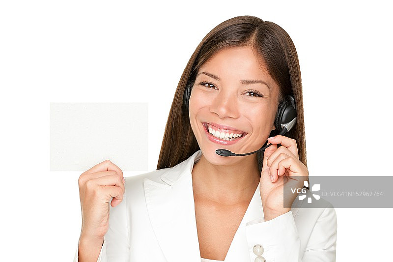 一个戴着呼叫中心耳机的女人举着一个空白的牌子图片素材
