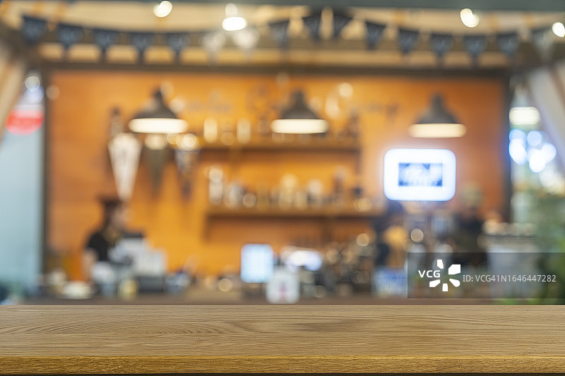 空的木制桌面与模糊的咖啡馆或餐厅内部背景图片素材