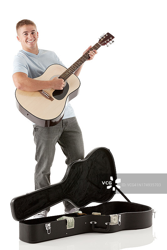 微笑的街头音乐家弹奏吉他图片素材